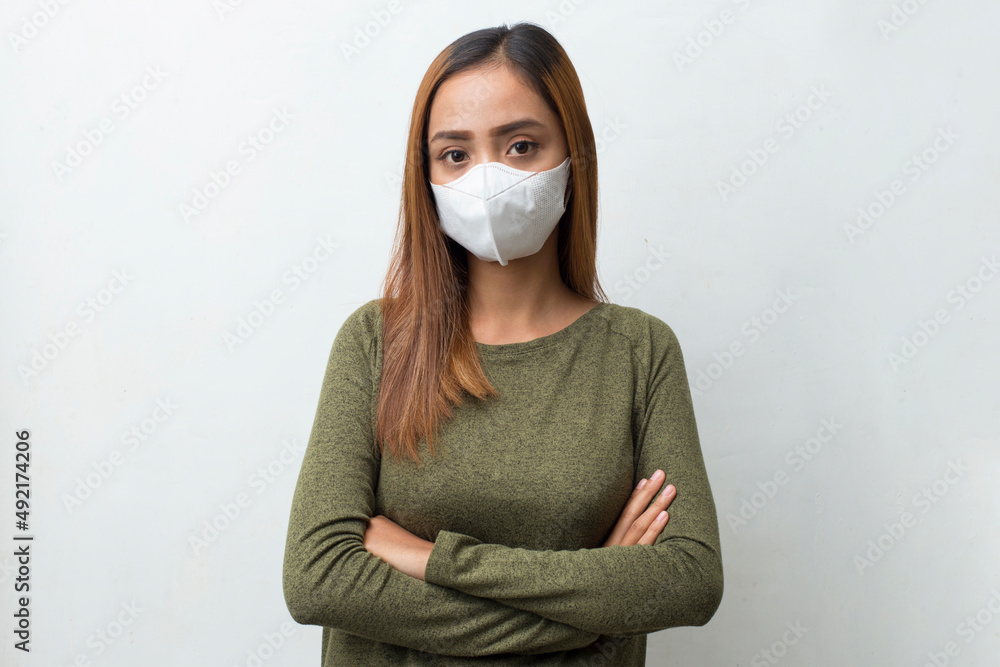 asian woman wearing medical face mask to protection corona virus, covid-19 posing on white background

