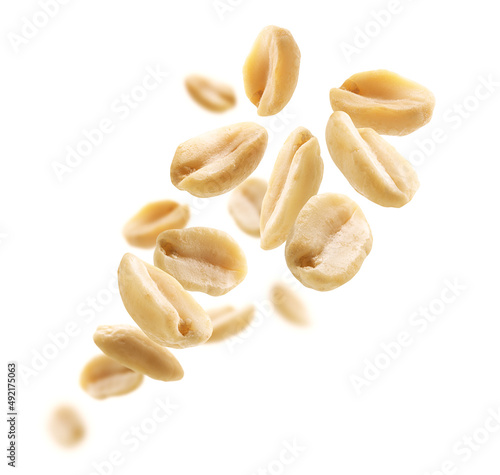 Peeled peanuts levitate on a white background photo