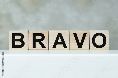 BRAVO word written on wood blocks on the a table photo
