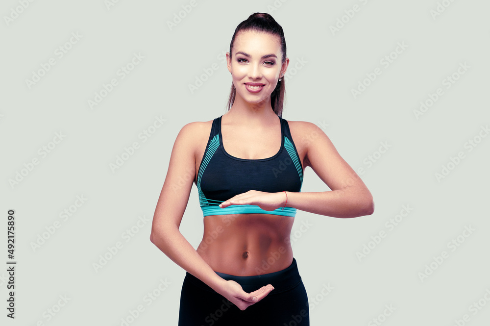 Sporty fitness woman with strong abs on isolated background Sporty fitness woman with strong abs on isolated background