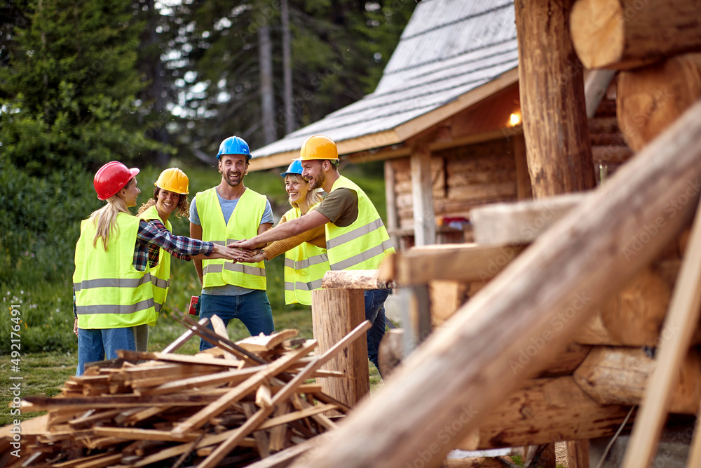 Teamwork construction workers.Construction workers together working on wooden house, Teamwork construction workers.Construction workers together working on wooden house,