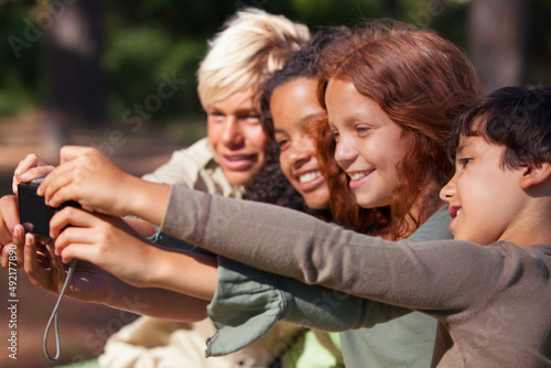 Making vacation memories. Shot of a group of children taking a self-portrait outdoors. © Marine G/peopleimages.com