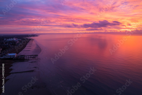 Fototapeta Naklejka Na Ścianę i Meble -  pink sunset over the town and pier