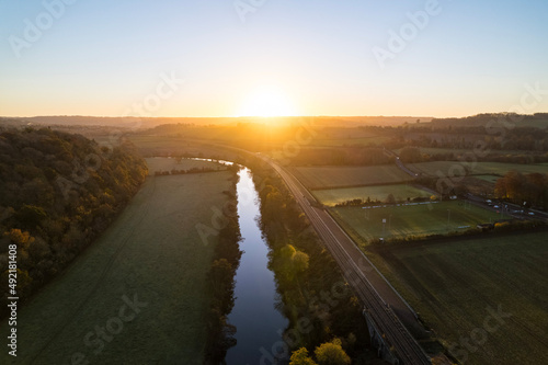 sunset over the river and train tracks