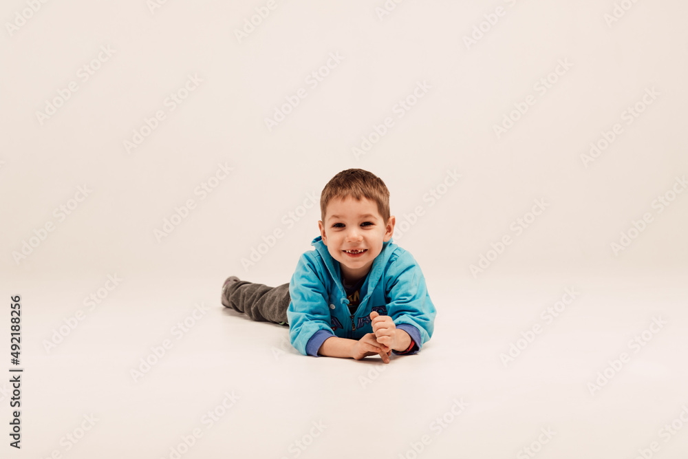 Little boy lies on the floor and smiles
Little boy lies on the floor and smiles