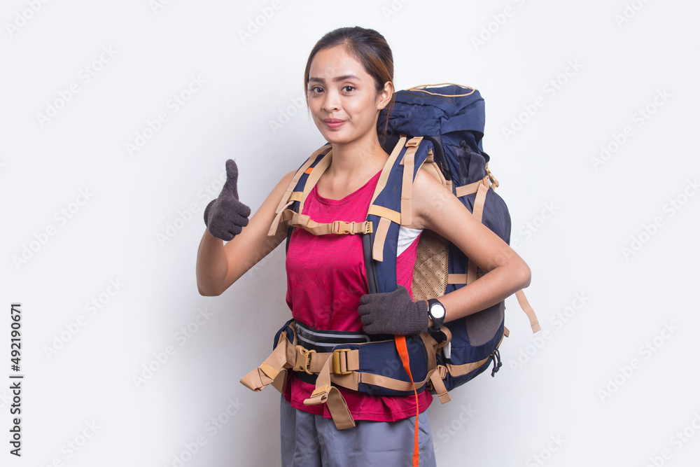 Young beautiful asian hiker woman with backpack showing a thumbs up ok gesture on white background
Young beautiful asian hiker woman with backpack showing a thumbs up ok gesture on white background