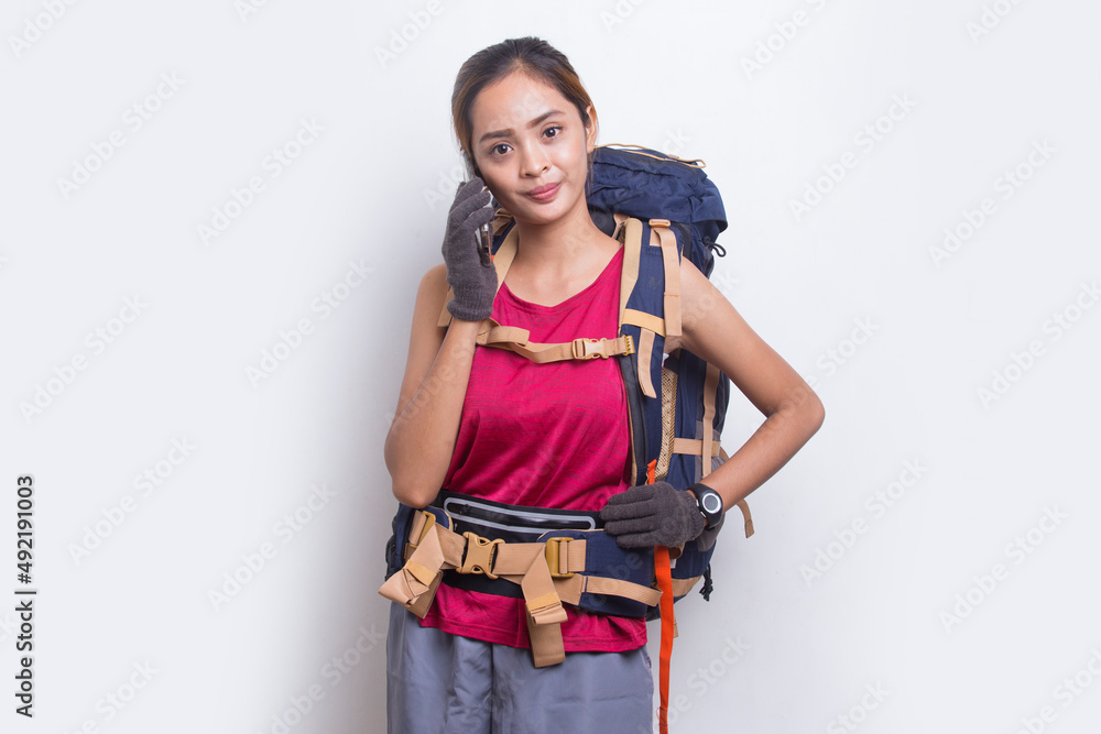 Young beautiful asian hiker woman using mobile phone isolated on white background
Young beautiful asian hiker woman using mobile phone isolated on white background