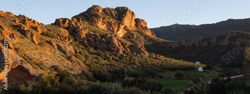 Panoramic view of the red hills in the Klein Karoo with small white cottages