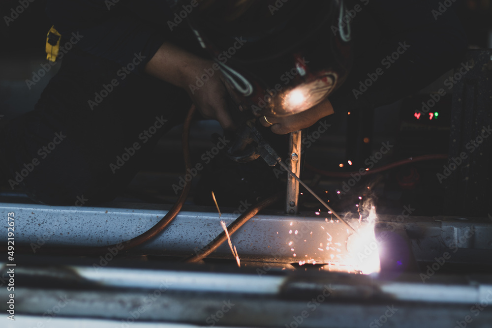welder, welding automotive part in a car factory welder, welding automotive part in a car factory