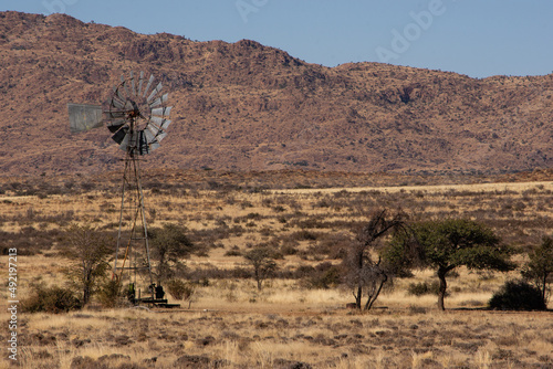 Windmill in the baren Namibian landscape photo