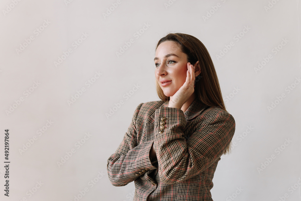 Portrait of a happy successful confident business woman in smart clothes washes and looks at the camera standing on a white isolated background. Space for text. Selective focus Portrait of a happy successful confident business woman in smart clothes washes and looks at the camera standing on a white isolated background. Space for text. Selective focus