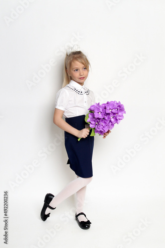 little girl posing with purple lilac flower