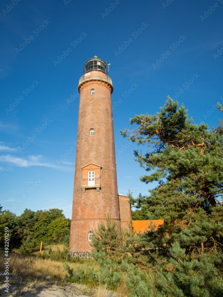Beautiful view of the famous landmark maritime lighthouse on the Darß peninsula near the Prerow in Germany