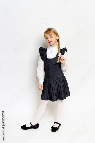 little girl posing in school uniform