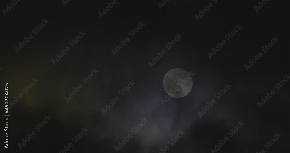 Full moon and windblown clouds in the night sky. Full moon and windblown clouds in the night sky.