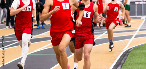 High school boys running a race on an indoor track