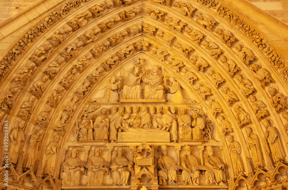 PARIS, FRANCE - JUNE 15. 2011: The detail from side portal of Notre-Dame cathedral at night