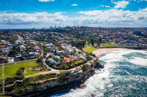 Aerial drone view of iconic Bronte Beach and nearby coastline in Sydney, Australia during summer on a sunny day 