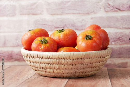 Fototapeta Naklejka Na Ścianę i Meble -  fresh tomato with water drop in a bowl on table 