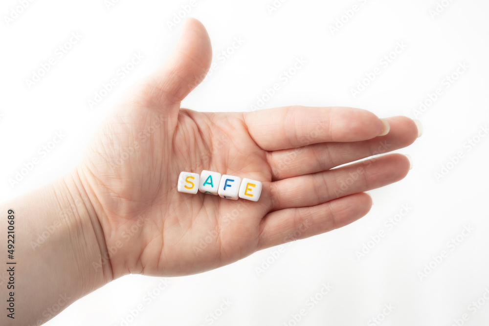 safe concept word from cubes in human hand safe concept word from cubes in human hand