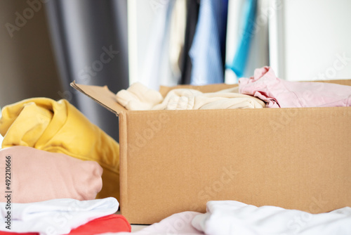 clothes in a box for recycling, second hand and charity, collection of things when moving