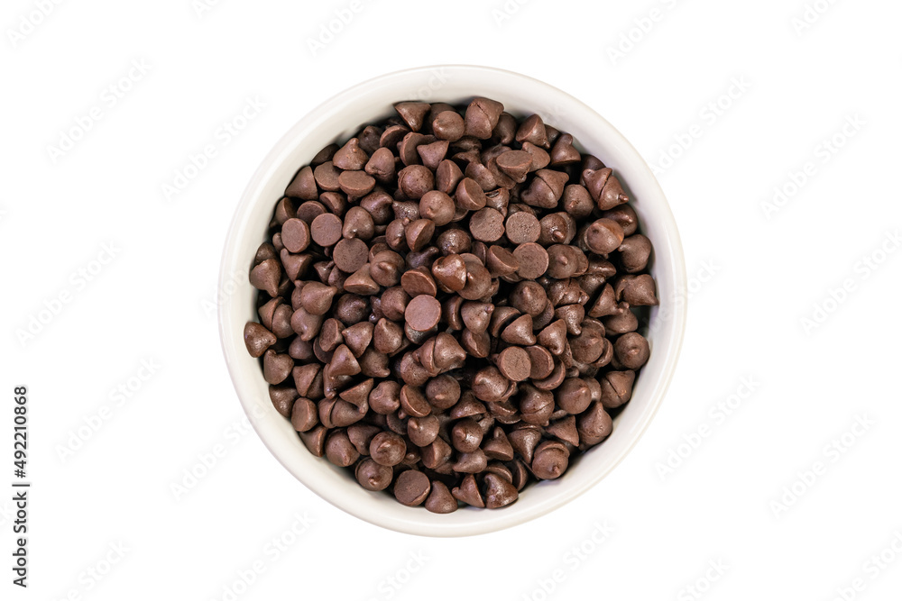 Top view pile of delicious chocolate chips in white ceramic cup on white background. Top view pile of delicious chocolate chips in white ceramic cup on white background.