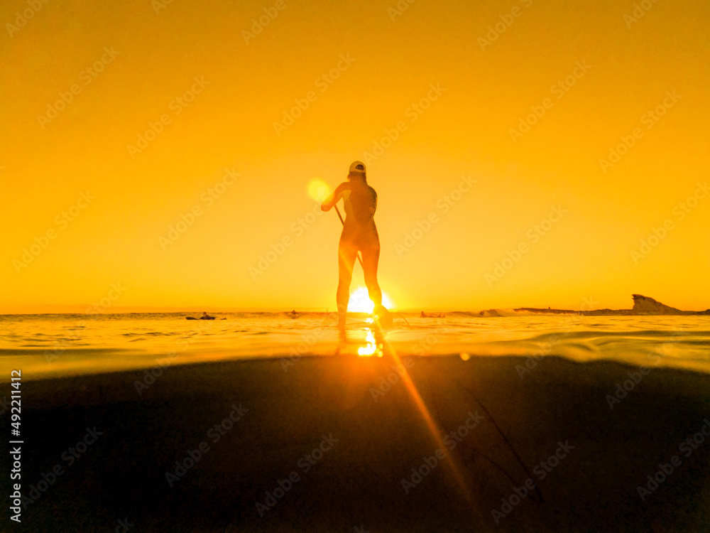 paddleboarding at sunrise 