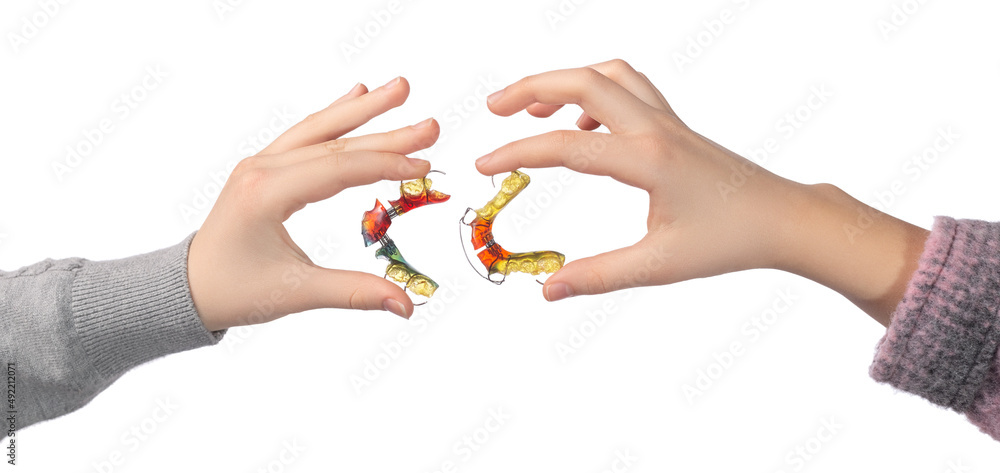Obraz premium Two children's hands with orthodontic appliances on a white background. The concept of oral hygiene in childhood.