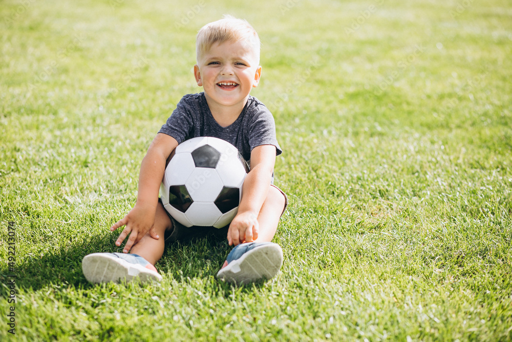 Father with son playing football at the field Father with son playing football at the field