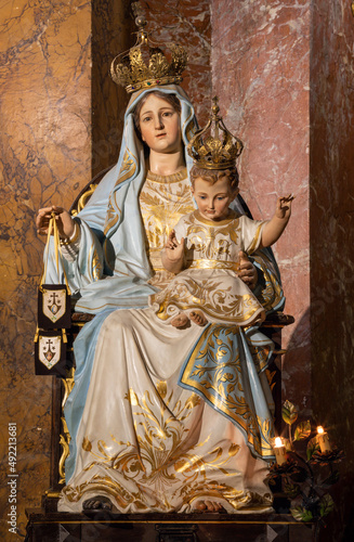 ROME, ITALY - AUGUST 29, 2021: The carved polychrome statue of Madonna (Our Lady of Mount Carmel) in the church Chiesa di Santa Maria della Scala by unknown artist. photo