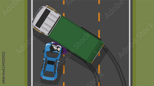 Accident top view of a container truck blocking the road. Car crashed into the side, causing severe damage to the front.