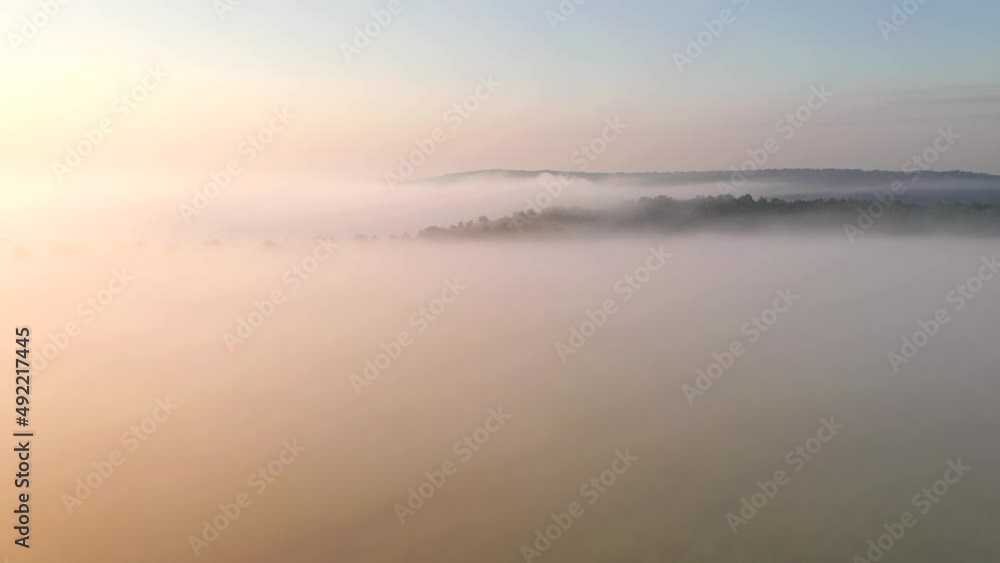 A shot from a drone over a thick fog that covered the plain before dawn. Filmed in UHD 4k video. A shot from a drone over a thick fog that covered the plain before dawn. Filmed in UHD 4k video.