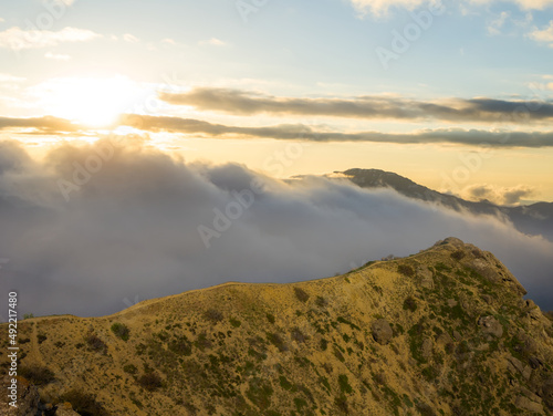 mountain ridge in dense mist at the sunset