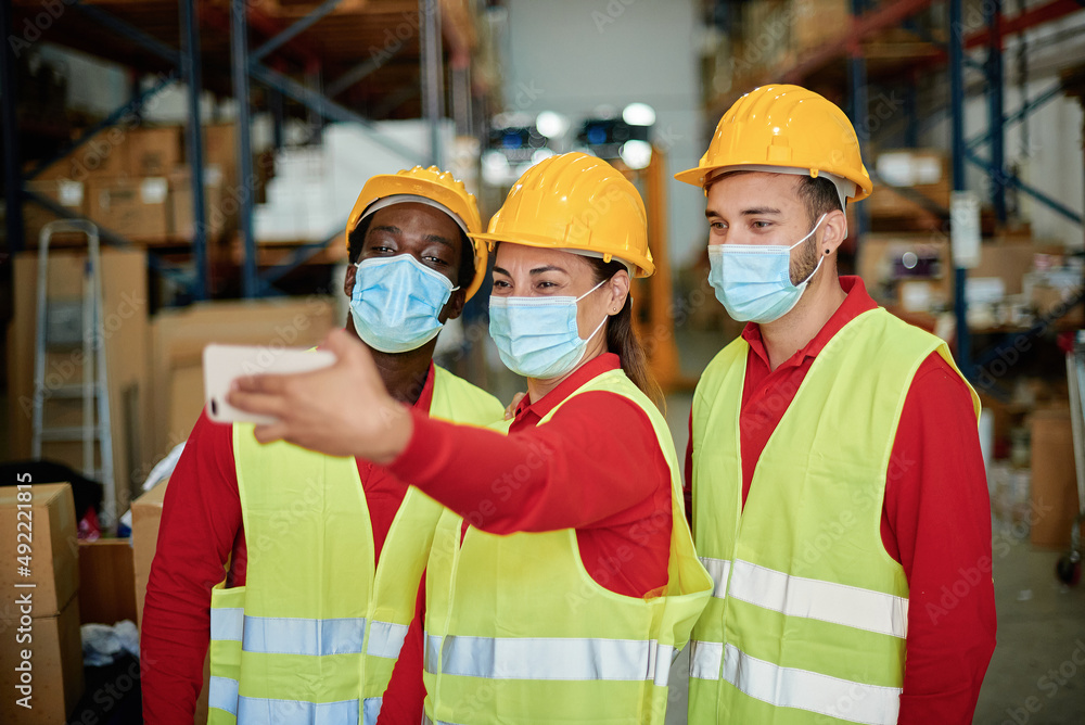 Factory worker in protective mask taking selfie Factory worker in protective mask taking selfie