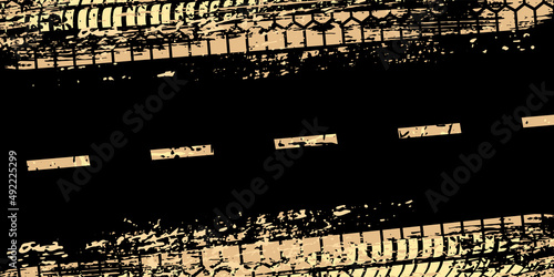 Car tire track pattern on black dirty road, abstract grunge effect of golden tyre trace