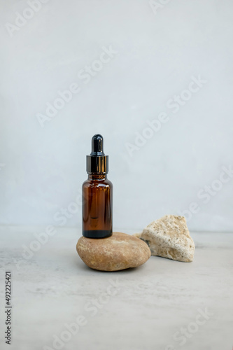 Brown dropper bottle with pipette. Cosmetic oil bottle mockup. Cosmetic product concept.