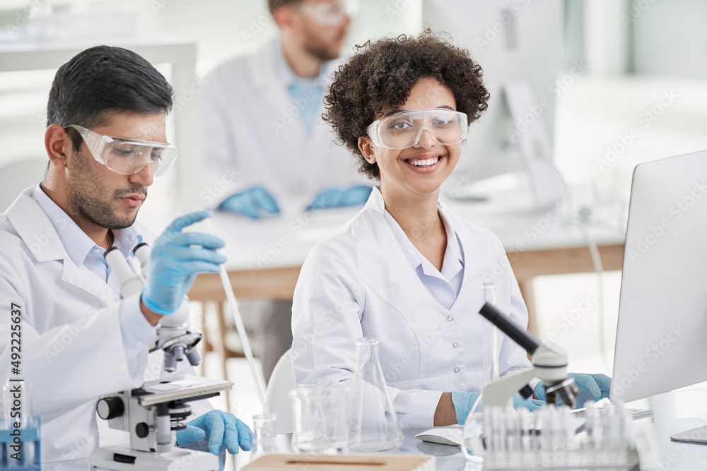 smiling female scientist at the workplace in the laboratory. smiling female scientist at the workplace in the laboratory.