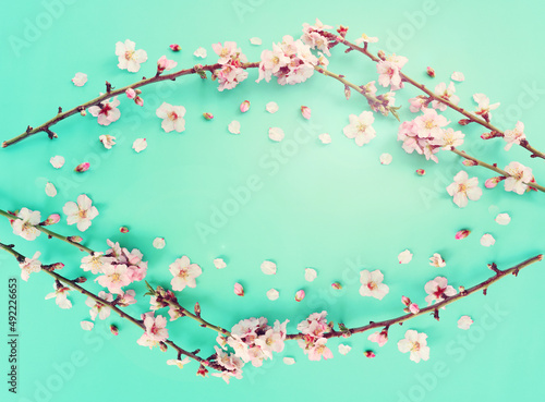 image of spring white cherry blossoms tree over mint pastel background. vintage filtered image
