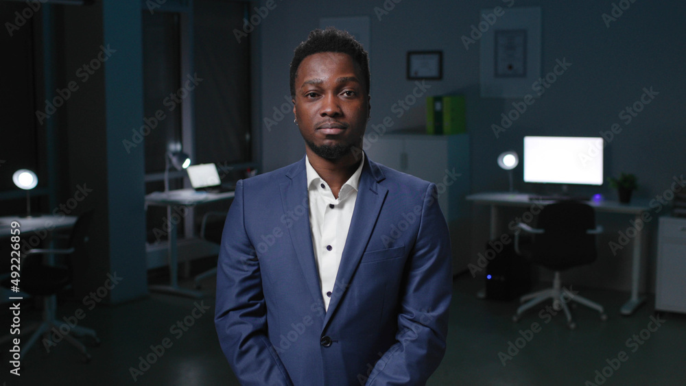 African-American businessman look at camera and in office. African-American businessman look at camera and in office.