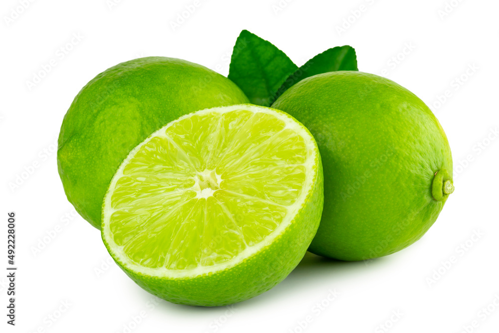 Lime citrus fruits in wholes and cut crosswise in half with leaves isolated on white background with clipping path, cutout. Lime citrus fruits in wholes and cut crosswise in half with leaves isolated on white background with clipping path, cutout.