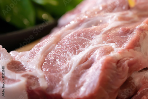 Canvas Print Close up macro shooting sliced pork meat on wood plate in studio light