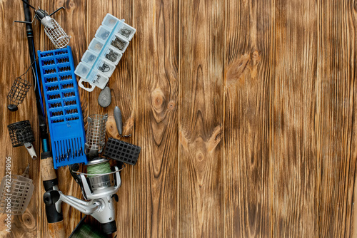 Wallpaper Mural flat lay with fishing tackle, fishing rod and plastic box with fishing tackle and hooks, feeders on wooden planks, copy space Torontodigital.ca