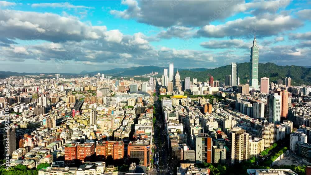 Aerial forward Flight over beautiful shining City of Taipei during cloudy and sunny day,Taiwan - Panorama view showing skyscraper buildings and 101 Tower with mountains in backdrop Aerial forward Flight over beautiful shining City of Taipei during cloudy and sunny day,Taiwan - Panorama view showing skyscraper buildings and 101 Tower with mountains in backdrop