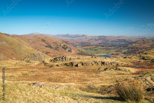A sunny, winter, landscape HDR image looking east across the lakeland fells with a distant Helvellyn and Howgill fells, Cumbria, England