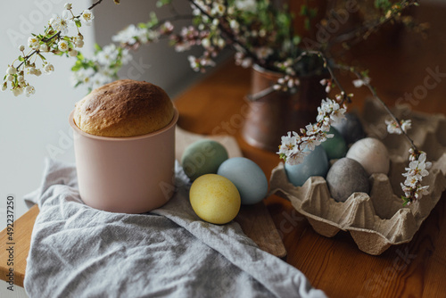 Canvas Print Homemade easter bread, natural dyed eggs and spring blossom on rustic table in room