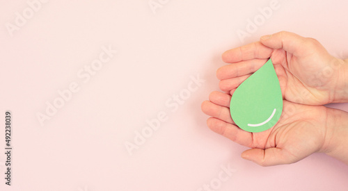 Holding a green drop, olive oil, alternative bio fuel, recycling resourses, sustainability lifestyle, ecology concept
 photo