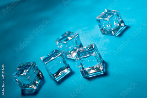 Clear ice cubes for cooling drinks on a blue background.