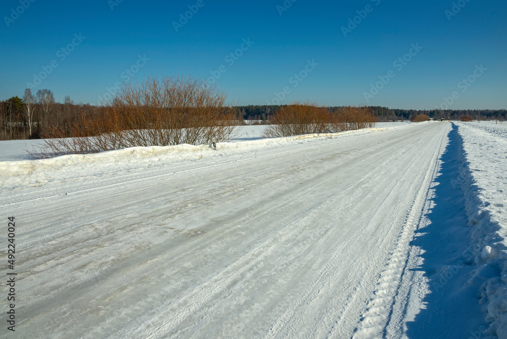 Winter country road on a sunny March day. Russia Winter country road on a sunny March day. Russia