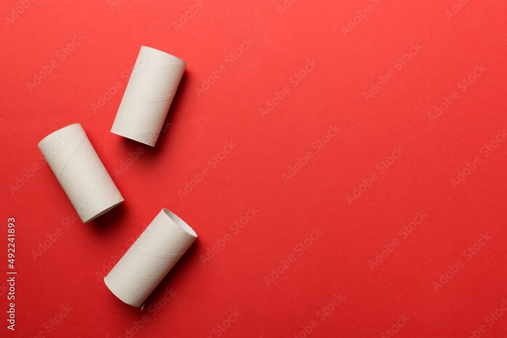 Flat lay composition with empty toilet paper rolls and space for text on color background. Recyclable paper tube with metal plug end made of kraft paper or cardboard Flat lay composition with empty toilet paper rolls and space for text on color background. Recyclable paper tube with metal plug end made of kraft paper or cardboard