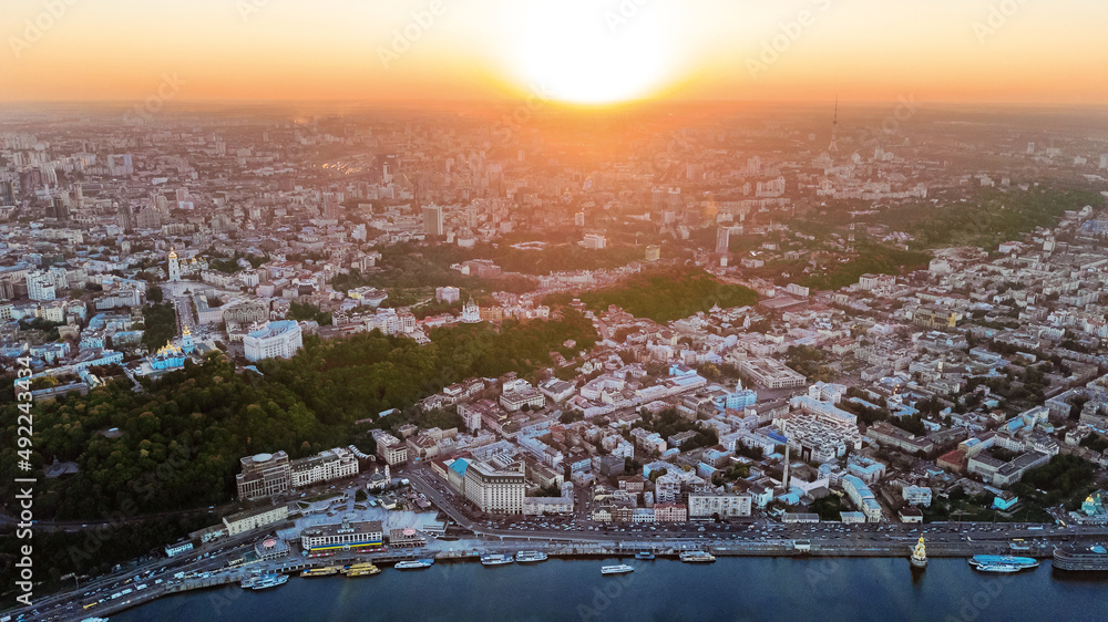 Aerial top view of Kyiv cityscape on sunset, downtown and Podol historical district skyline from above, city of Kiev, Ukraine
